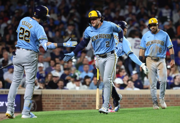 Milwaukee Brewers second baseman Brice Turang (2) is congratulated by teammate Christian Yelich (22) after Turang hit a two-run home run in the eighth inning of a game against the Chicago Cubs at Wrigley Field in Chicago on May 19, 2026. (Chris Sweda/Chicago Tribune)
