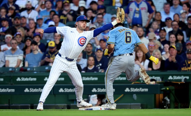 Milwaukee Brewers shortstop David Hamilton (6) is safe at first base on a bunt single as Chicago Cubs second baseman Nico Hoerner takes a late throw in the fourth inning of a game at Wrigley Field in Chicago on May 19, 2026. (Chris Sweda/Chicago Tribune)