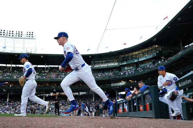 Chicago Cubs third baseman Alex Bregman (left), center fielder Pete Crow-Armstrong (center), and right fielder Seiya Suzuki (right), head out of the dugout to start a game against the Milwaukee Brewers at Wrigley Field in Chicago on May 19, 2026. (Chris Sweda/Chicago Tribune)