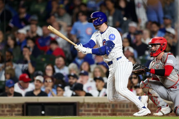 Cubs second baseman Nico Hoerner (2) hits a single during the third inning against the Reds at Wrigley Field May 4, 2026, in Chicago. (Armando L. Sanchez/Chicago Tribune)
