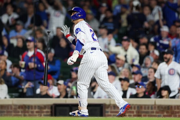 Cubs right fielder Seiya Suzuki (27) throws his bat after hitting a three-run homer during the fourth inning against the Reds at Wrigley Field May 4, 2026, in Chicago. (Armando L. Sanchez/Chicago Tribune)