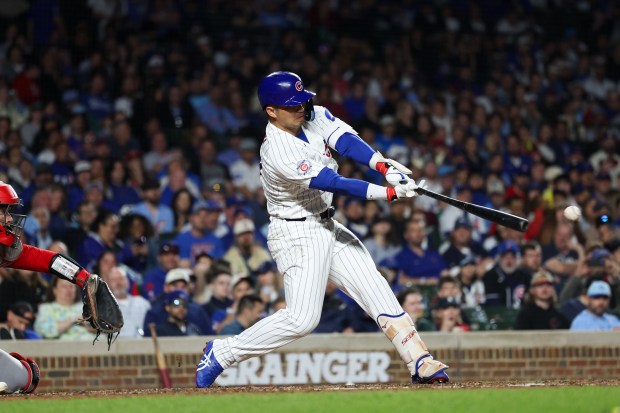 Cubs right fielder Seiya Suzuki (27) hits a single during the sixth inning against the Reds at Wrigley Field May 4, 2026, in Chicago. (Armando L. Sanchez/Chicago Tribune)