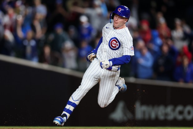 Cubs center fielder Pete Crow-Armstrong (4) hits a triple during the ninth inning against the Reds at Wrigley Field May 4, 2026, in Chicago. (Armando L. Sanchez/Chicago Tribune)