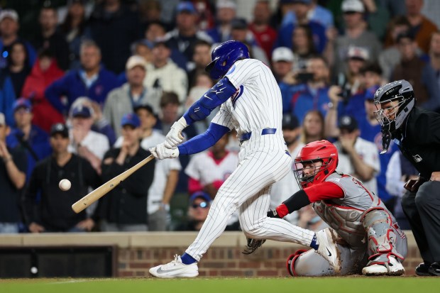 Cubs second baseman Nico Hoerner (2) hits a sacrifice-fly bringing in Cubs center fielder Pete Crow-Armstrong (4) during the ninth inning at Wrigley Field May 4, 2026, in Chicago. (Armando L. Sanchez/Chicago Tribune)
