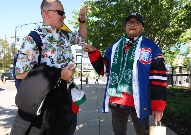 Chicago sports fans Dian Penchev, left, and Matthew Bejar joke with each other while walking outside of Rate Field before a White Sox-Cubs game on May 15, 2026, in Chicago. (John J. Kim/Chicago Tribune)