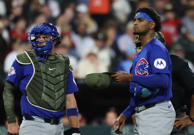 Cubs starting pitcher Edward Cabrera, right, waits for a PitchCom device switch in the fifth inning against the White Sox at Rate Field on May 15, 2026, in Chicago. (John J. Kim/Chicago Tribune)