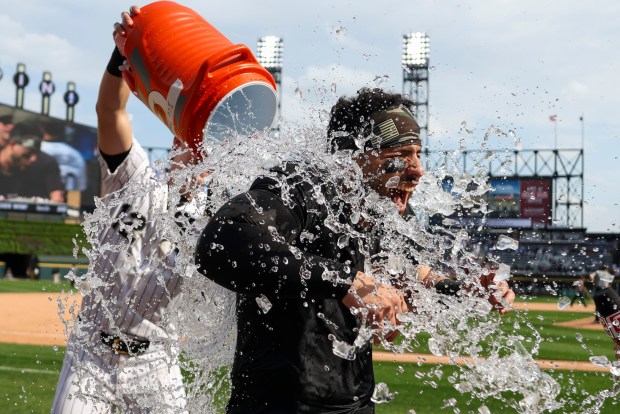 Chicago White Sox shortstop Colson Montgomery (12) dumps ice water on catcher Edgar Quero (26) while he does an interview after he hit a two-run home run during the 10th inning to defeat the Chicago Cubs 9-8 at Rate Field on May 17, 2026. (Eileen T. Meslar/Chicago Tribune)