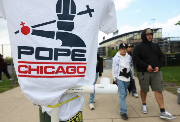 A Pope Leo XIV T-shirt is displayed for sale on West 37th Street outside at Rate Field before a White Sox-Mariners game on May 8, 2026, in Chicago. (John J. Kim/Chicago Tribune)