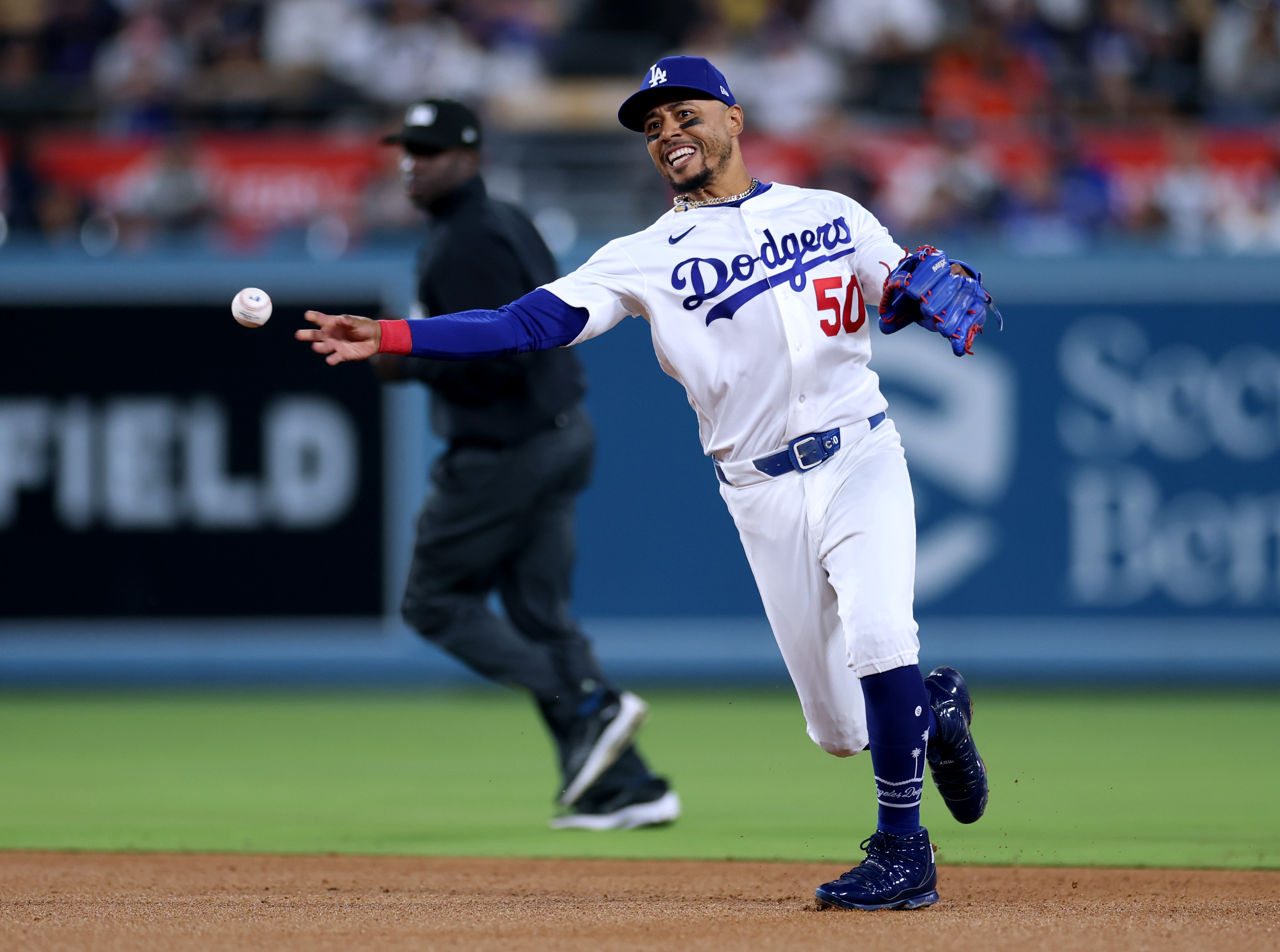 Dodgers shortstop Mookie Betts throws to first base on a...