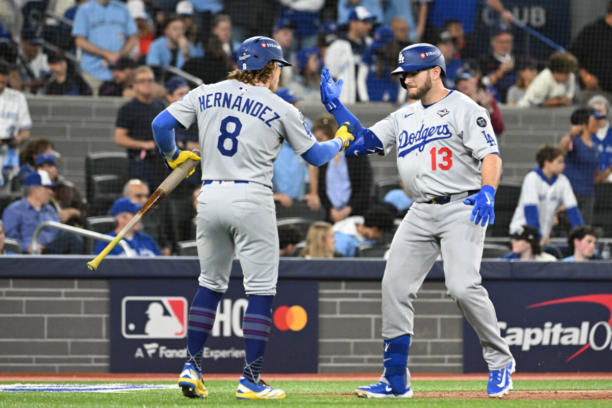 Oct 25, 2025; Toronto, Ontario, CAN; Los Angeles Dodgers third baseman Max Muncy (13) celebrates after hitting a solo home run against the Toronto Blue Jays with left fielder Enrique Hernandez (8) in the seventh inning during game two of the 2025 MLB World Series at Rogers Centre. Mandatory Credit: Dan Hamilton-Imagn Images