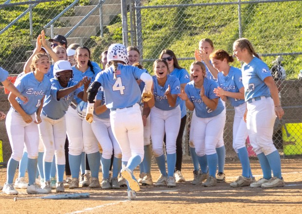 Blue Mountain's Avery Hudock (4) is celebrated by her teammates at home plate during a the Schuylkill League semifinals against Schuylkill Haven on May 12, 2026. (AISHWARYA BEHL/STAFF PHOTO)