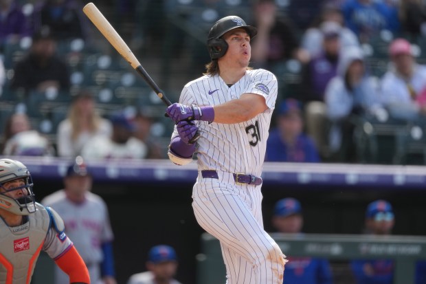 Colorado Rockies' Jake McCarthy follows the flight of his grand slam off New York Mets relief pitcher Craig Kimbrel in the eighth inning of a baseball game, Thursday, May 7, 2026, in Denver. (AP Photo/David Zalubowski)