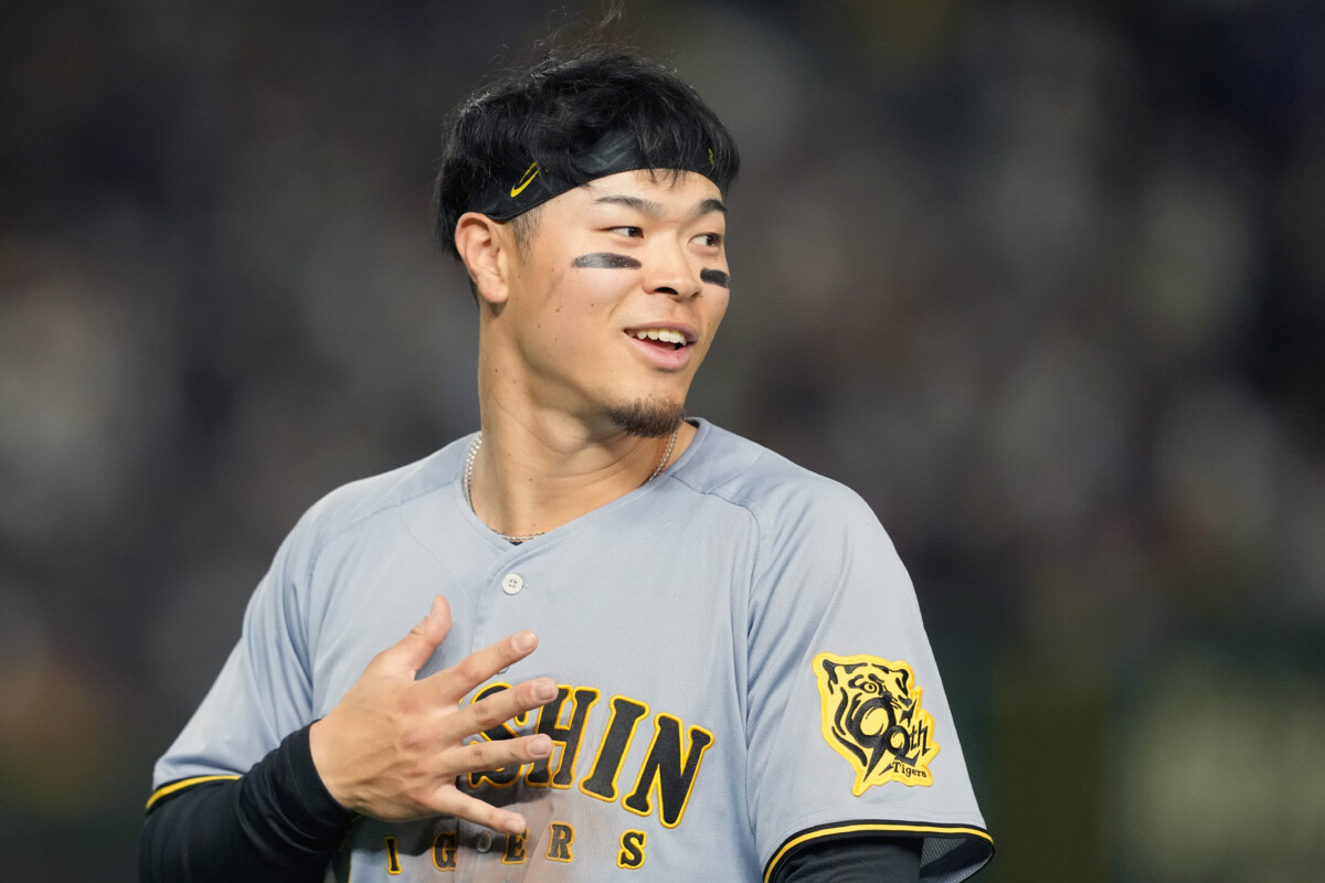 Mar 15, 2025; Bunkyo, Tokyo, Japan; Hanshin Tigers right fielder Teruaki Sato (8) during the fifth inning against the Chicago Cubs at Tokyo Dome. Mandatory Credit: Darren Yamashita-Imagn Images