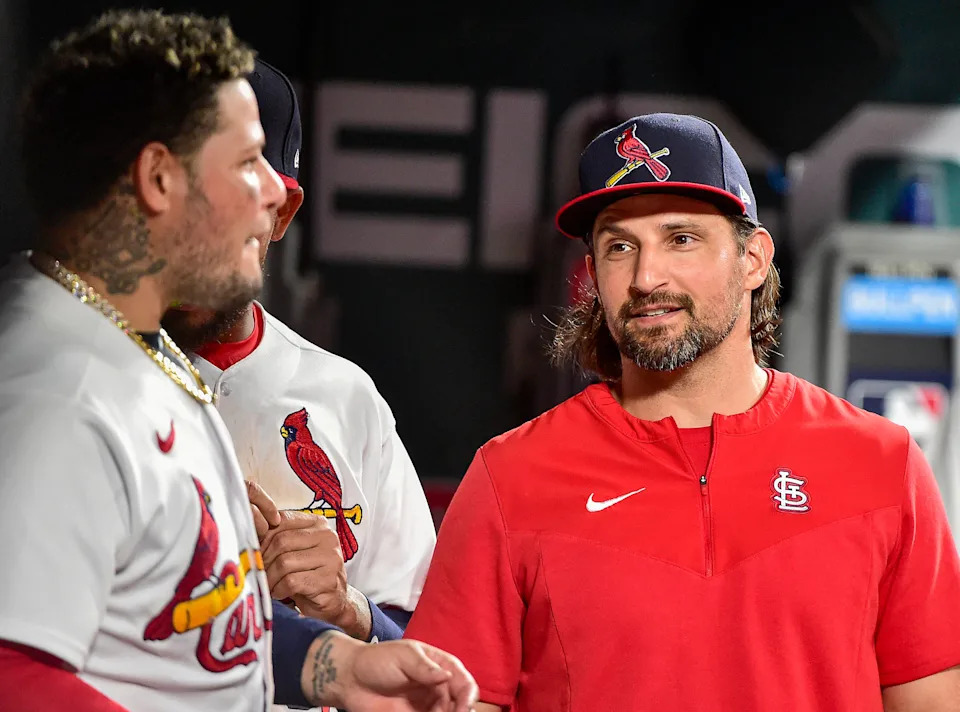 Newly acquired Guardians catcher modeled his game after longtime St. Louis Cardinals backstop Yadier Molina, left.