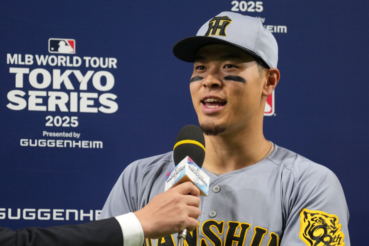 Mar 16, 2025; Bunkyo, Tokyo, Japan; Hanshin Tigers third baseman Teruaki Sato (8) is interviewed after defeating the Los Angeles Dodgers at Tokyo Dome. Mandatory Credit: Darren Yamashita-Imagn Images