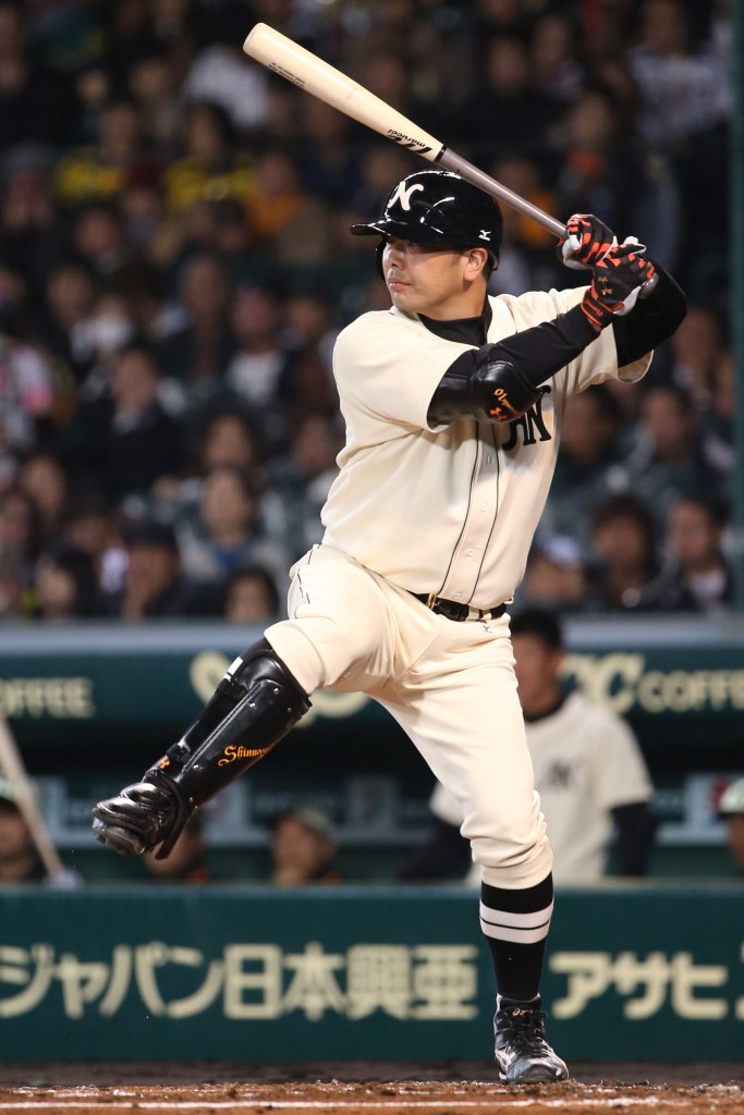 Shinnosuke Abe #10 of Hanshin Tigers batting during a friendly match.
