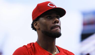 Cincinnati Reds starting pitcher Hunter Greene (21) walks