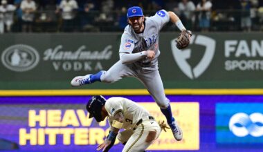 Oct 11, 2025; Milwaukee, Wisconsin, USA; Chicago Cubs shortstop Dansby Swanson (7) throws to first on a double play against Milwaukee Brewers shortstop Joey Ortiz (3) in the third inning during game five of the NLDS round for the 2025 MLB playoffs at American Family Field. Mandatory Credit: Benny Sieu-Imagn Images