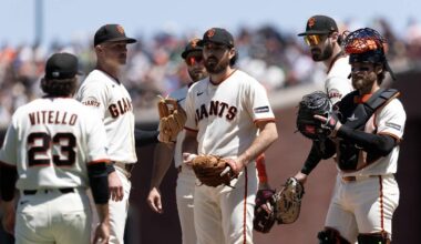 San Francisco, California, USA; San Francisco Giants pitcher Ryan Walker (center) waits to be relieved by manager Tony Vitello (23) during the seventh inning against the Athletics at Oracle Park. Mandatory Credit: D. Ross Cameron-Imagn Images