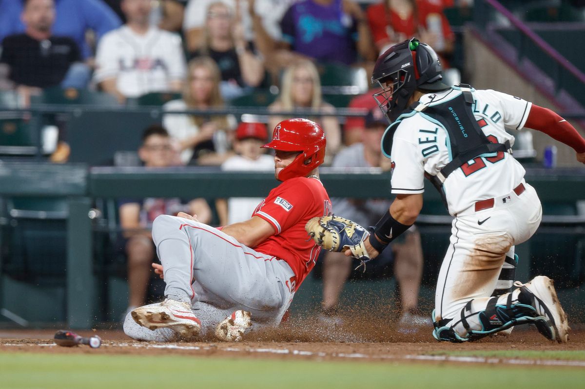 Logan O'Hoppe #14 of the Los Angeles Angels is tagged out a home plate against the Arizona Diamondbacks at Chase Field on June 16, 2026 in Phoenix, Arizona. Logan O'Hoppe #14 of the Los Angeles Angels is tagged out a home plate against the Arizona Diamondbacks at Chase Field on June 16, 2026 in Phoenix, Arizona.