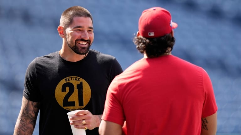 San Diego Padres' Nick Castellanos, left, talks with Philadelphia Phillies'...