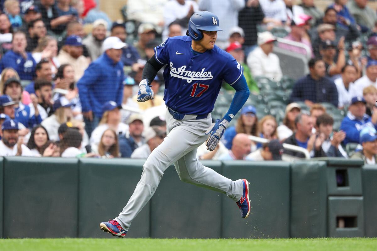 Shohei Ohtani rounds third base to score on a single by Tommy Edman in the first inning.