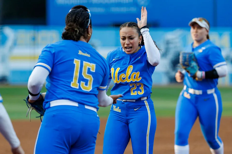 UCLA starting pitcher Taylor Tinsley celebrates with first baseman Jordan Woolery during an NCAA super regional game.