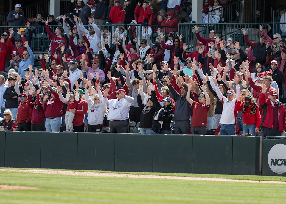 Apr 18, 2026; Fayetteville, AR, USA; Arkansas Razorbacks fans “call the hogs” during the seventh inning stretch in the game against the Georgia Bulldogs at Baum-Walker Stadium. Georgia won 26-14. Mandatory Credit: Brett Rojo-Imagn Images
