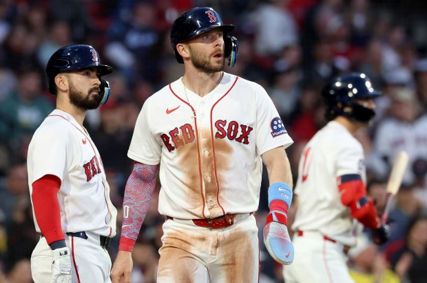 Boston Red Sox shortstop Trevor Story reacts after sliding safely into home plate to score during the second inning of a baseball game against the Tampa Bay Rays, Thursday, May 7, 2026, in Boston. (AP Photo/Mark Stockwell)