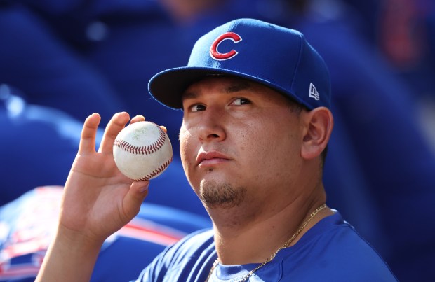 Cubs pitcher Javier Assad holds a ball in the dugout during Game 1 of the NL Division Series against the Brewers at American Family Field on Oct. 4, 2025, in Milwaukee. (Chris Sweda/Chicago Tribune)