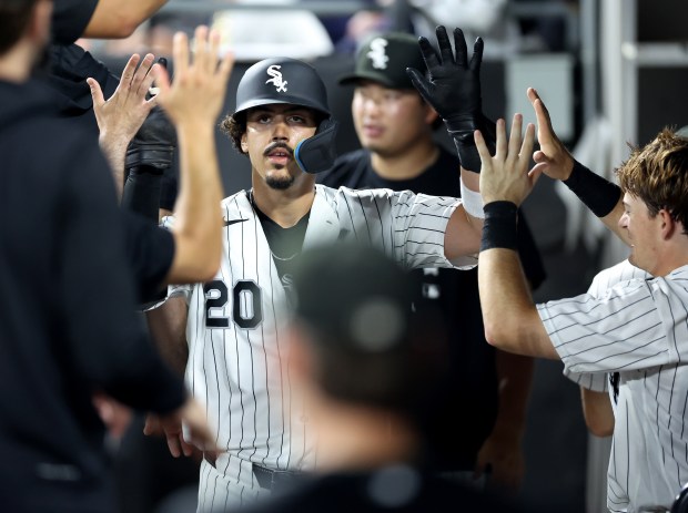 Chicago White Sox third baseman Miguel Vargas (20) is congratulated by his teammates in the dugout after scoring a run on a single by Jacob Gonzalez in the seventh inning of a game at Rate Field in Chicago on June 9, 2026. (Chris Sweda/Chicago Tribune)