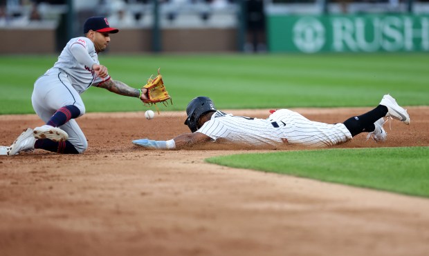 Cleveland Guardians shortstop Brayan Rocchio is unable to handle a throw from the catcher as Chicago White Sox shortstop Luisangel Acuña steals second base in the fifth inning of a game at Rate Field in Chicago on June 23, 2026. (Chris Sweda/Chicago Tribune)