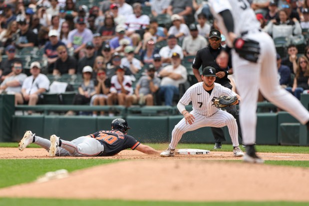 Chicago White Sox first baseman Jacob Gonzalez (7) catches a throw from Chicago White Sox pitcher Sean Burke (59) as they try to keep Detroit Tigers Kerry Carpenter close to the bag in the fourth inning at Rate Field on May 31, 2026. (Eileen T. Meslar/Chicago Tribune)