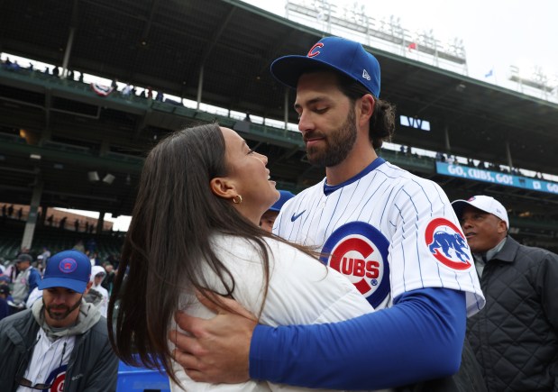 Cubs shortstop Dansby Swanson hugs his wife, Stars striker Mallory Swanson, after a game on March 30, 2023, at Wrigley Field. (John J. Kim/Chicago Tribune)