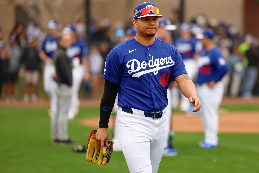 Dodgers player wearing uniform number 48 walking on the field with a baseball glove.