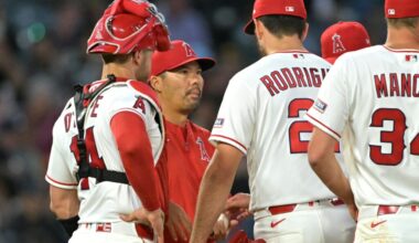 Jun 8, 2026; Anaheim, California, USA; Los Angeles Angels catcher Logan O'Hoppe (14) looks on as manager Kurt Suzuki (8) pulls starting pitcher Grayson Rodriguez (21) during the sixth inning against the Houston Astros at Angel Stadium. Mandatory Credit: Jayne Kamin-Oncea-Imagn Images