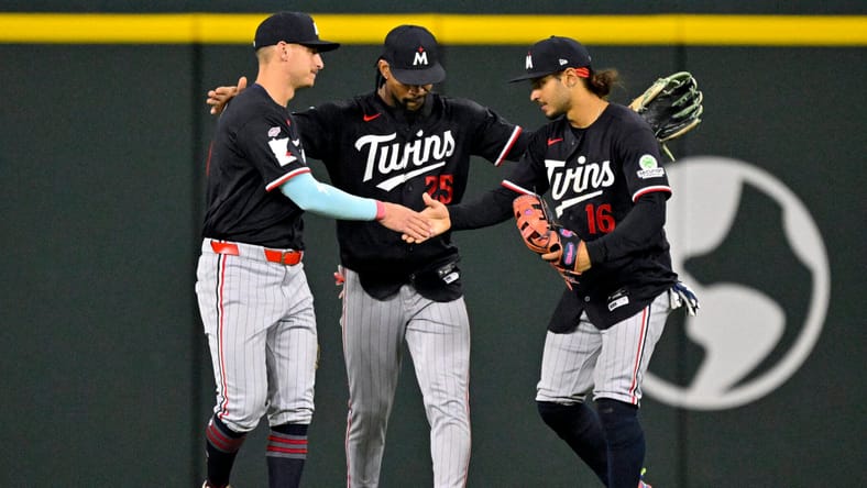 Byron Buxton embraces Minnesota Twins teammates in the outfield after win vs the Texas Rangers
