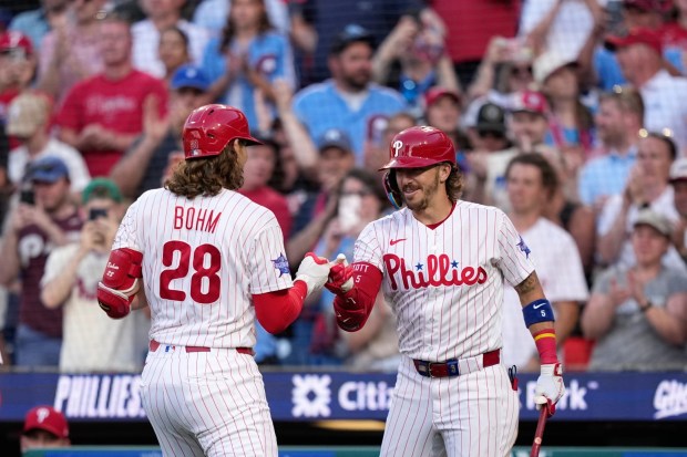 The Philadelphia Phillies' Alec Bohm, left, and Bryson Stott celebrate after Bohm's two-run home run against Miami Marlins pitcher Tyler Phillips during the second inning of a baseball game Tuesday, June 16, 2026, in Philadelphia. (AP Photo/Matt Slocum)