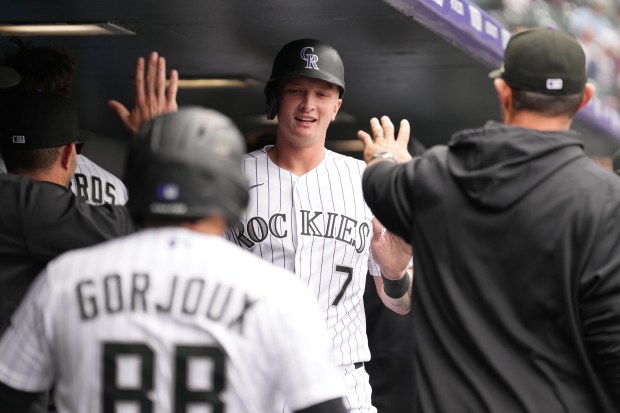 TJ Rumfield, first baseman for the Colorado Rockies, greets teammates in the dugout after scoring a run against the San Diego Padres at Coors Field in Denver on Thursday, April 23, 2026. (Photo by Harmon Dobson/The Denver Post)