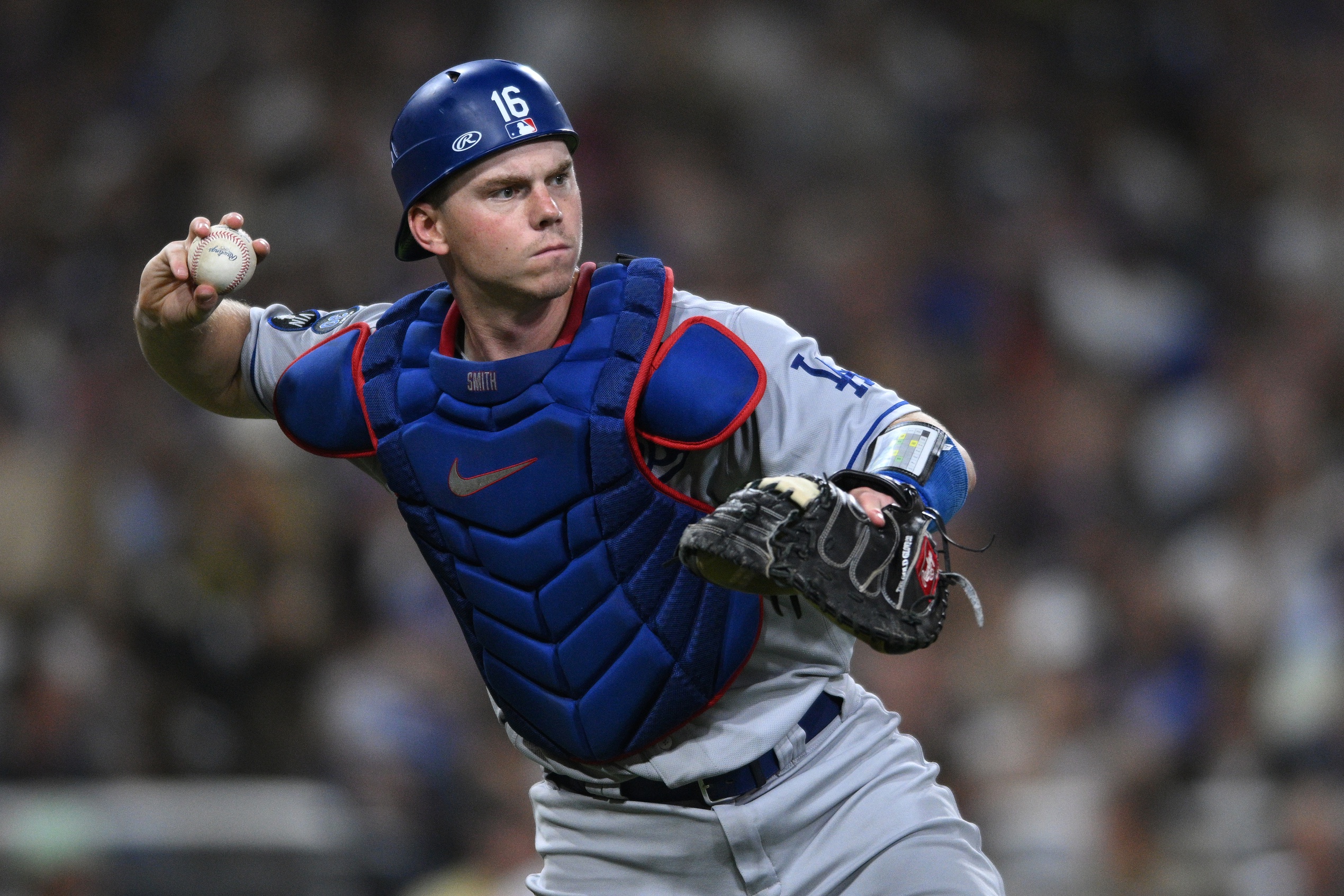 Sep 28, 2022; San Diego, California, USA; Los Angeles Dodgers catcher Will Smith (16) throws to first base on a ground out by San Diego Padres left fielder Jurickson Profar (not pictured) during the fourth inning at Petco Park. Mandatory Credit: Orlando Ramirez-USA TODAY Sports