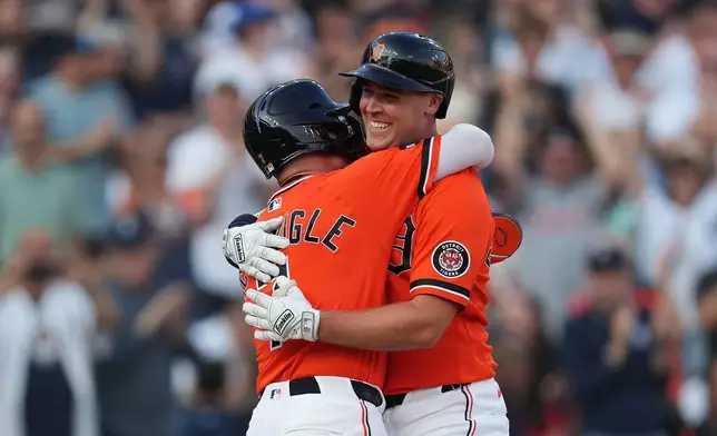 Detroit Tigers' Kerry Carpenter, right, celebrates his two-run home run with Kevin McGonigle, left, against the Houston Astros during the third inning of a baseball game Friday, June 26, 2026, in Detroit. (AP Photo/Paul Sancya)