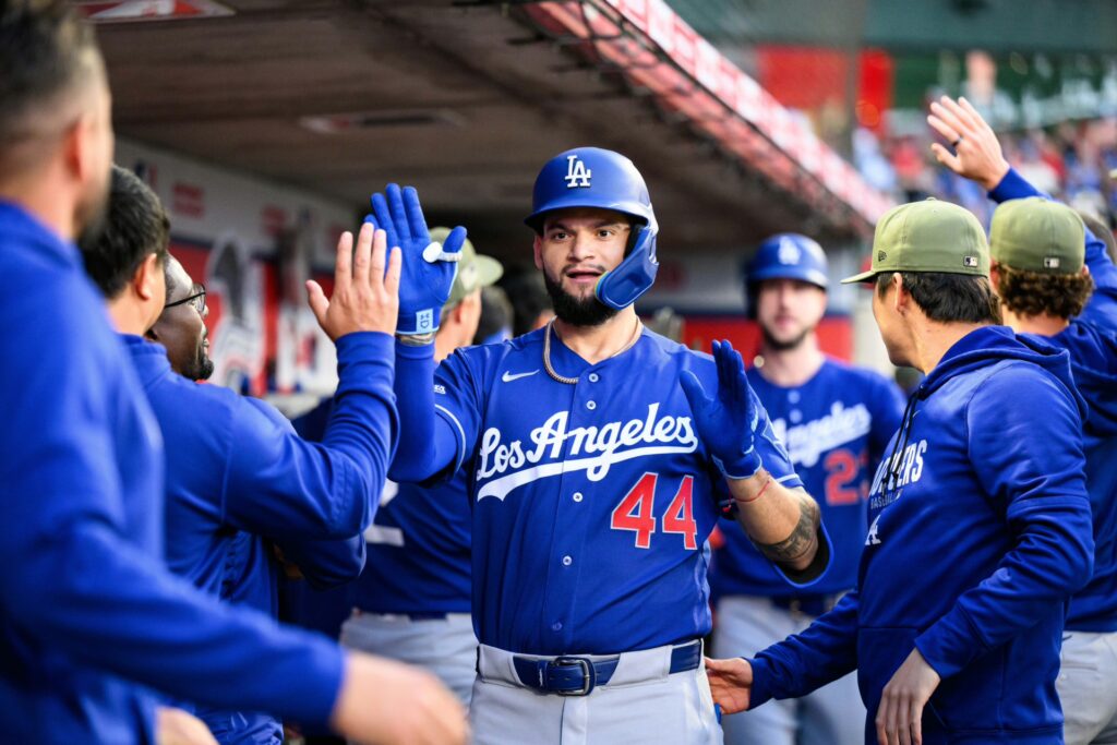 Los Angeles Dodgers center fielder Andy Pages (44) is greeted by teammates after hitting a home run during the fourth inning against the Los Angeles Angels at Angel Stadium.