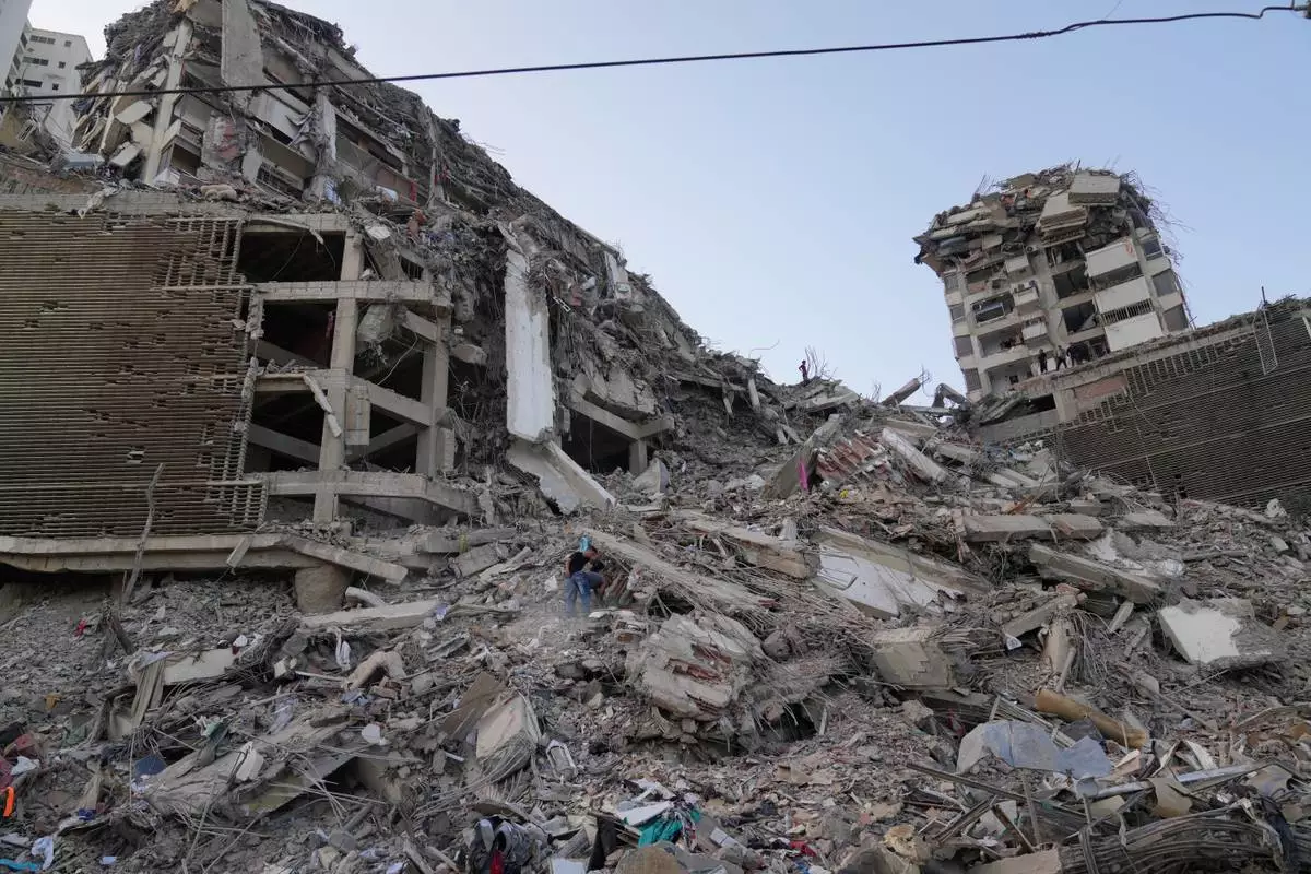 Residents search through the rubble two days after an earthquake struck La Guaira, Venezuela, Friday, June 26, 2026. (AP Photo/Ariana Cubillos)