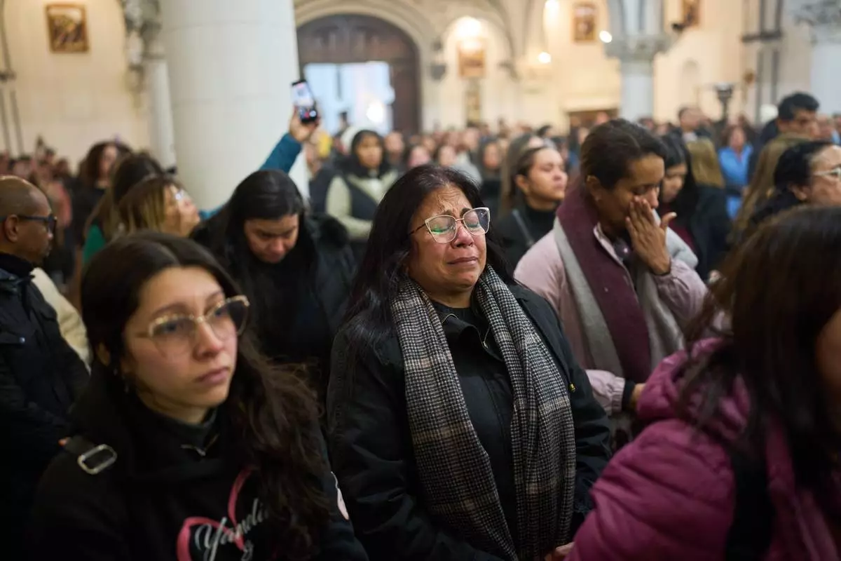 People attend a mass to honor the victims of the earthquakes in Venezuela, in Buenos Aires, Argentina, Thursday, June 25, 2026. (AP Photo/Rodrigo Abd)