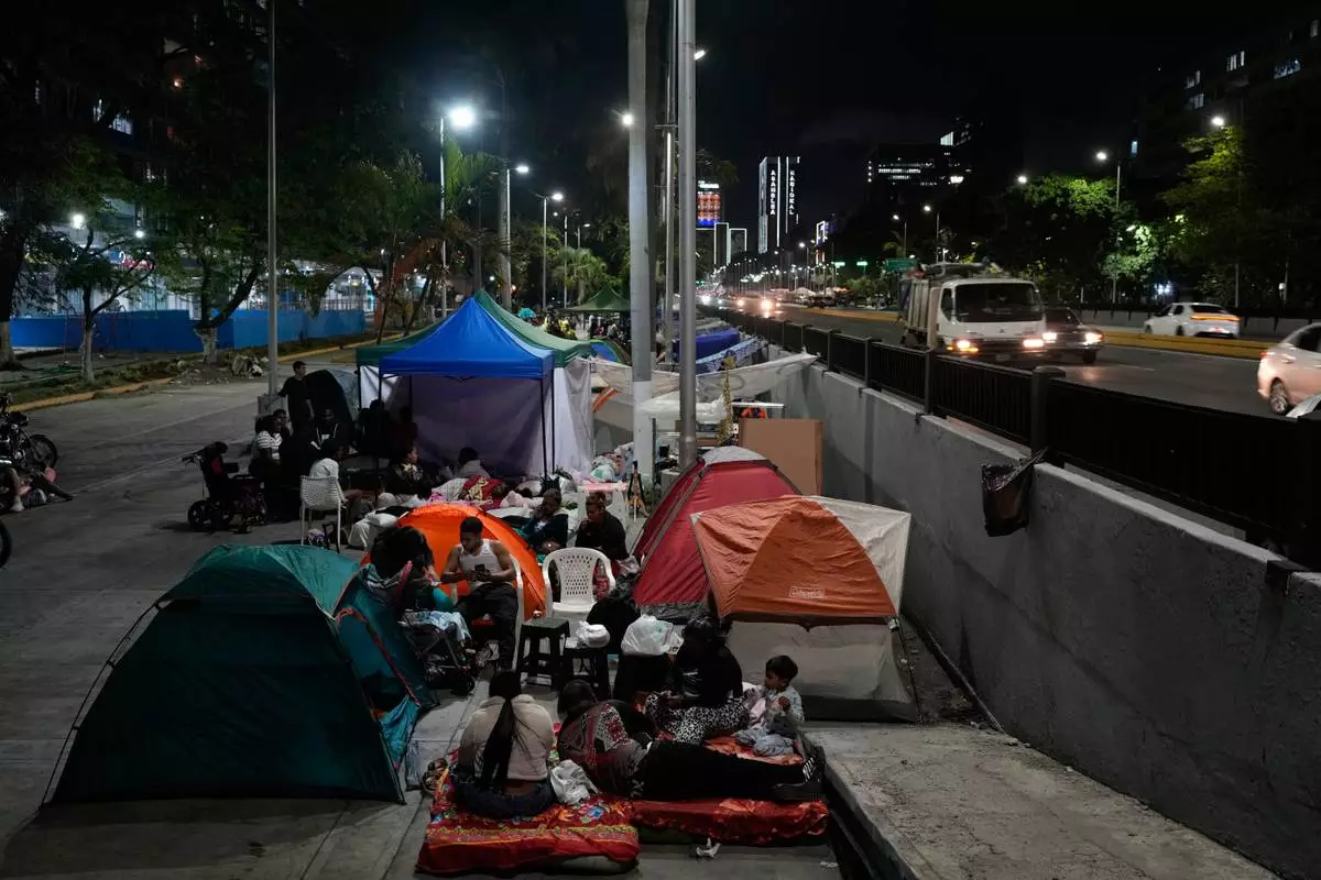 People camp in the street the night after the earthquake struck Caracas, Venezuela, Thursday, June 25, 2026. (AP Photo/Ariana Cubillos)