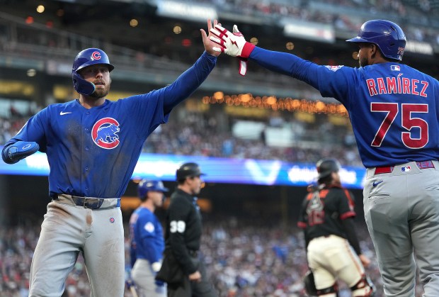 Michael Busch of the Chicago Cubs is congratulated by Pedro Ramírez after Busch stole home against the San Francisco Giants in the top of the third inning at Oracle Park on June 13, 2026, in San Francisco. (Thearon W. Henderson/Getty Images)