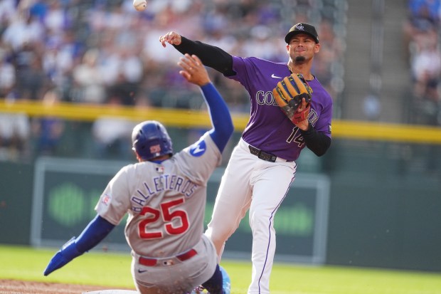 Colorado Rockies shortstop Ezequiel Tovar, back, throws over Chicago Cubs' Moisés Ballesteros after forcing him out at second base on the front end of a double play hit into by Michael Busch to end the top of the first inning of a baseball game Tuesday, June 9, 2026, in Denver. (AP Photo/David Zalubowski)