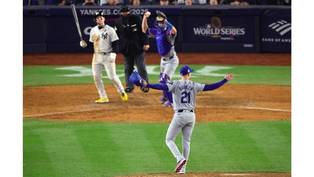 Dodgers pitcher Walker Buehler (21) and catcher Will Smith begin to celebrate after Buehler struck out the New York Yankees' Alex Verdugo, left, for the final out of their 7-6 victory in Game 5 of the 2024 World Series last October at Yankee Stadium. The ball is going up for auction to benefit L.A. wildfire recovery efforts. (Photo by Alex Slitz/Getty Images)