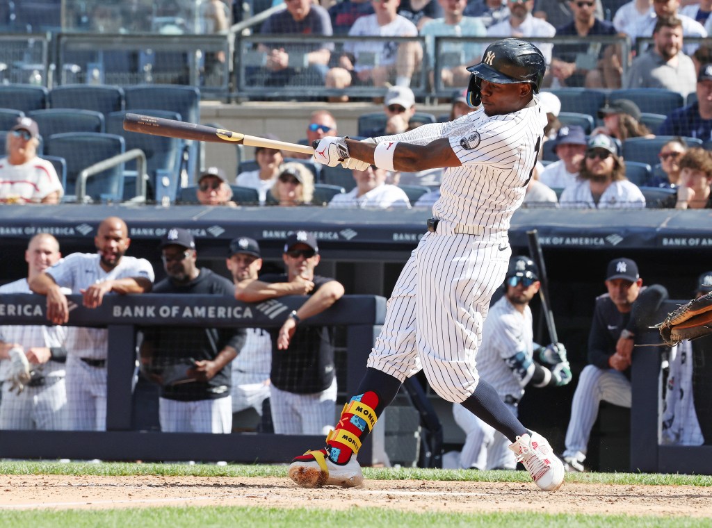 New York Yankees second baseman Jazz Chisholm Jr. in action, swinging the bat.