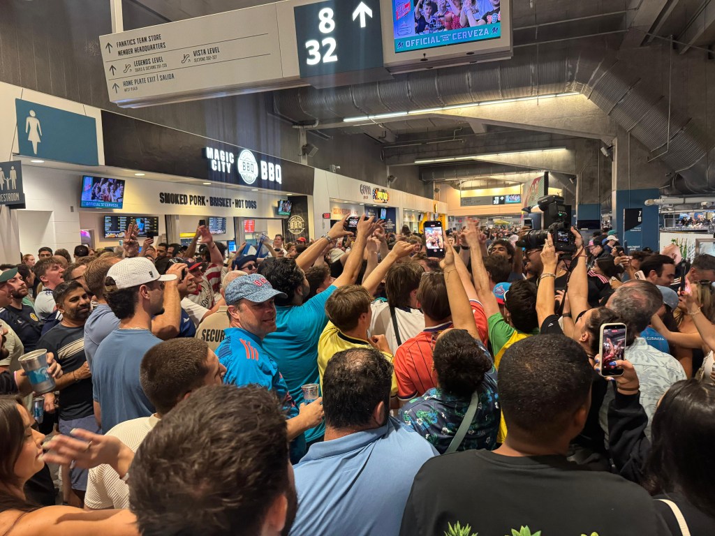Fans hold up phones to capture a moment at the Miami Marlins LoanDepot Park.